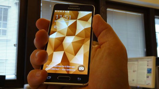 Samsung Galaxy Alpha ligger som støpt i en normalt stor herrehånd.