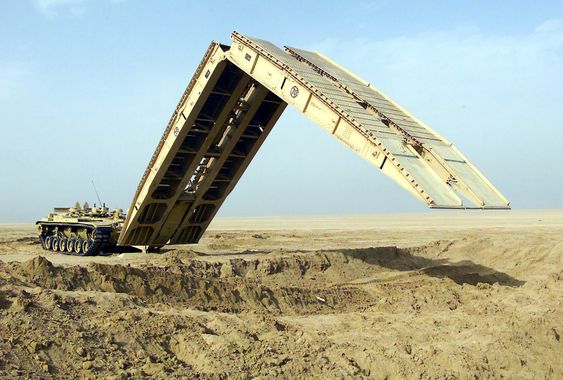 030206-M-5753Q-011Camp Coyote, Kuwait (Feb. 6, 2003) -- An M60A1 Armored Vehicle Landing Bridge (AVLB) practices the deployment of its 60 foot bridge span, designed to quickly move heavy military wheeled and tracked vehicles over unstable or hazardous terrain.  The equipment is being used in exercises being conducted as part of Operation Enduring Freedom.  U.S. Marine Corps photo by Lance Cpl. Kevin Quihuis Jr.  (RELEASED) 