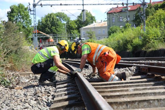 Micael Anderson og Harald Olsen fra Norsk Jernbanedrift legger skinner på Østfoldbanen etter at sporene ble revet i forbindelse med bygging av en ny bru over den kommende byggegropa til Follobanen. 