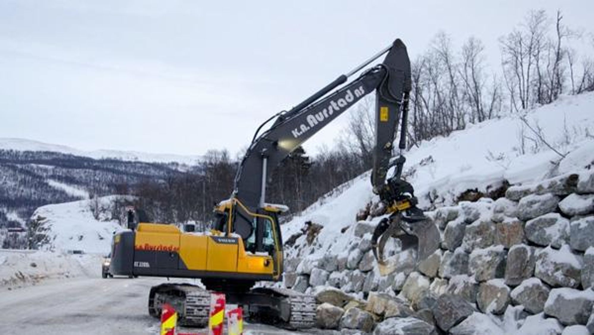 Her er en av gravemaskinene fra underentreprenør K. A. Aurstad i arbeid med natursteinmur på strekningen.