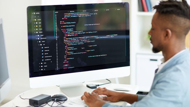 Web-utvikler foran en PC-skjerm.