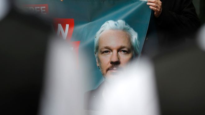 Plakat med bilde av Julian Assange under en demonstrasjon utenfor domstolen i London fredag.