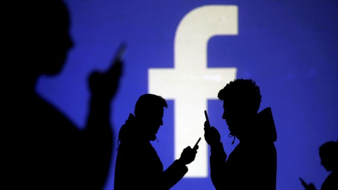 Silhuetter foran Facebooks logo.