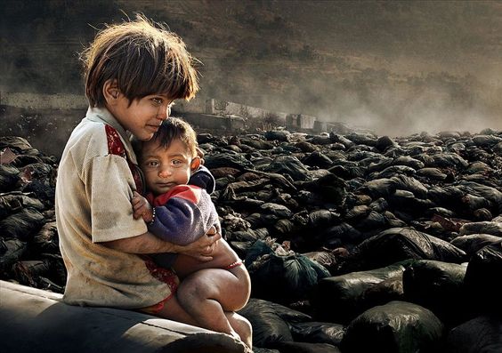 Winner - Two children who live nearby to the junkyard with their grandmother in Kathmandu, Nepal. Every day they search the junkyard for something useful that they can resell for money so they can buy food. If they don't find anything their grandmother blames them. Unfortunately, they had found nothing for a few days and the little boy feels very hungry. The photographer gave them some money and a biscuit after taking this photo. Foto: Chan Kwok Hung ( BULLS ) 