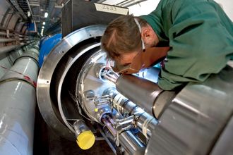 En sveiser fullfører en av de siste koblingene på Large Hadron Collider (LHC) i 2007.