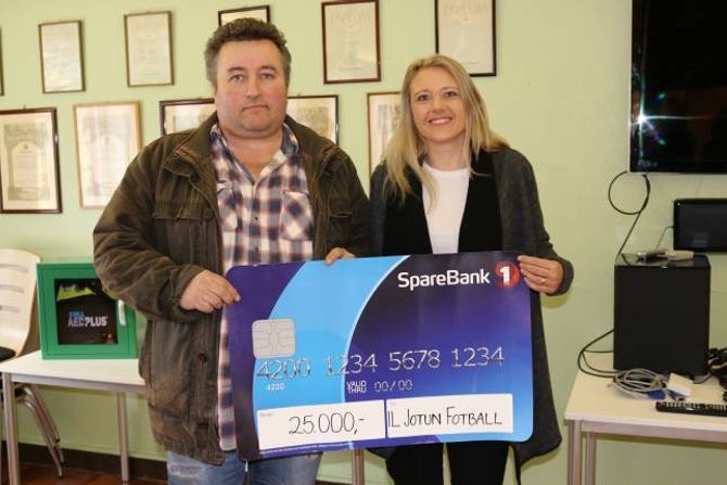 TAKKSAM: Leiar for fotballgruppa i Jotun, Henrik Rønningen, fekk ein sjekk på 25.000 kroner av Aina Heggø i Sparebank 1.