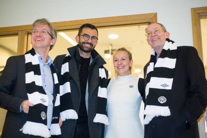 AKTIV VERVING: Eit godt vertskap let ikkje gjestane gå tomhendte heim, det har Stine Lilloe-Olsen i Sogndal Fotball skjønt. Delegasjonen frå kommunaldepartementet poserer villig vekk i sogndalskjerf.