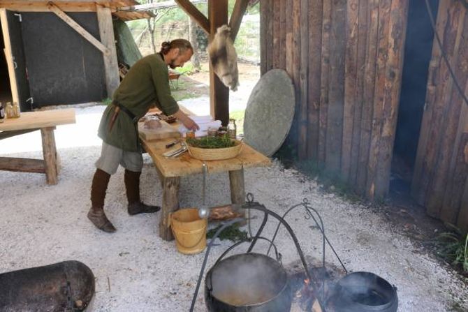 KAFÈ: Viking-John gjer i stand til opninga av vikingkafèen; i grytene putrar grønsakssuppe og urtete