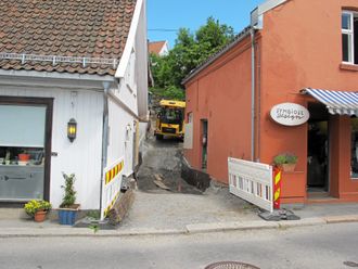 Det umulige blir mulig når «Samuel» har rygget dumperen på plass gjennom smuget for fylling av neste lass. Han må rygge, for det er ikke plass på tomta å snu.