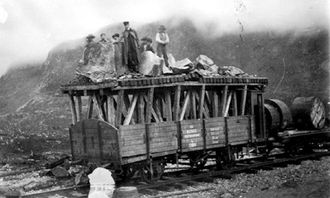 Kassevogn med oppbygg for tunnelrensk med mannskap, etter ras over vognen i Hundalen tunnel. Kabeltromler med telegrafkabler er med på lasset.