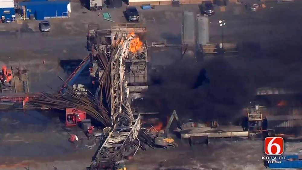 In this photo provided from a frame grab from Tulsa&#039;s KOTV/NewsOn6.com, fires burn at an eastern Oklahoma drilling rig near Quinton, Okla., Monday Jan. 22, 2018. Five people are missing after a fiery explosion ripped through a drilling rig, sending plumes of black smoke into the air and leaving a derrick crumpled on the ground, emergency officials said. (Christina Goodvoice, KOTV/NewsOn6.com via AP)