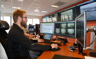 Prosessoperatør Frede Kristoffersen følger med mens det blåses ut tonnevis med laksepellets lenger sør i fylket. Fôringa må overvåkes og styres for å få et godt oppdrettsmiljø.