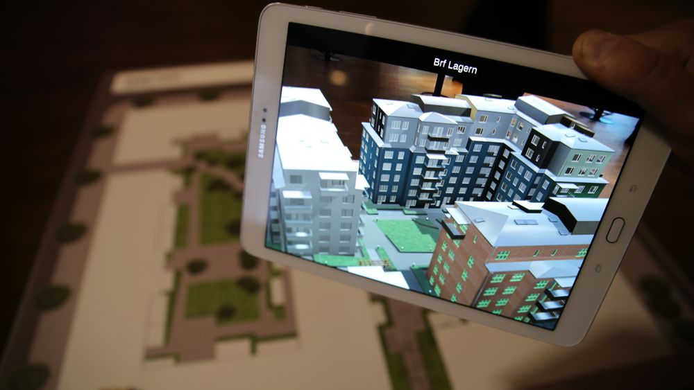En AR-app får 3D-modellene til å vise seg på skjermen når du retter den mot plantegningen. Modellen til venstre er hvit i dette tilfellet fordi den tilhører et påfølgende byggetrinn.