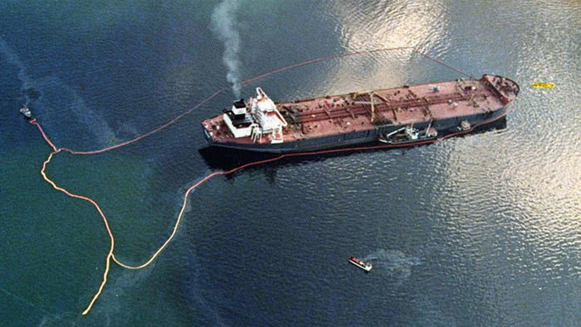Oljelenser rundt Exxon Valdez i Prins Williamsundet i Alaska. Skipet grunnstøtte på Barrier Reef 24. mars 1989.
