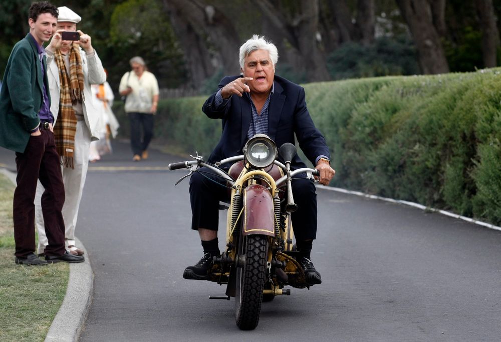 TV personality Jay Leno rides a 1930 Bohmerland motorcycle around the grounds during the Concours d&#039;Elegance at the Pebble Beach Golf Links in Pebble Beach, California, August 17, 2014. The Concours tops a week-long celebration of automobiles and car culture on the Monterey Peninsula. REUTERS/Michael Fiala (UNITED STATES - Tags: SOCIETY TRANSPORT ENTERTAINMENT BUSINESS TPX IMAGES OF THE DAY)
