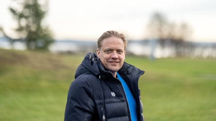 Portrett av Henrik Green, halvfigur med boblejakke i parklandskap.