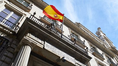 En lys bygning i nyklassisk stil med det spanske flagget vaiende fra balkongen.