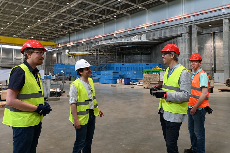 People talking together inside the factory hall.